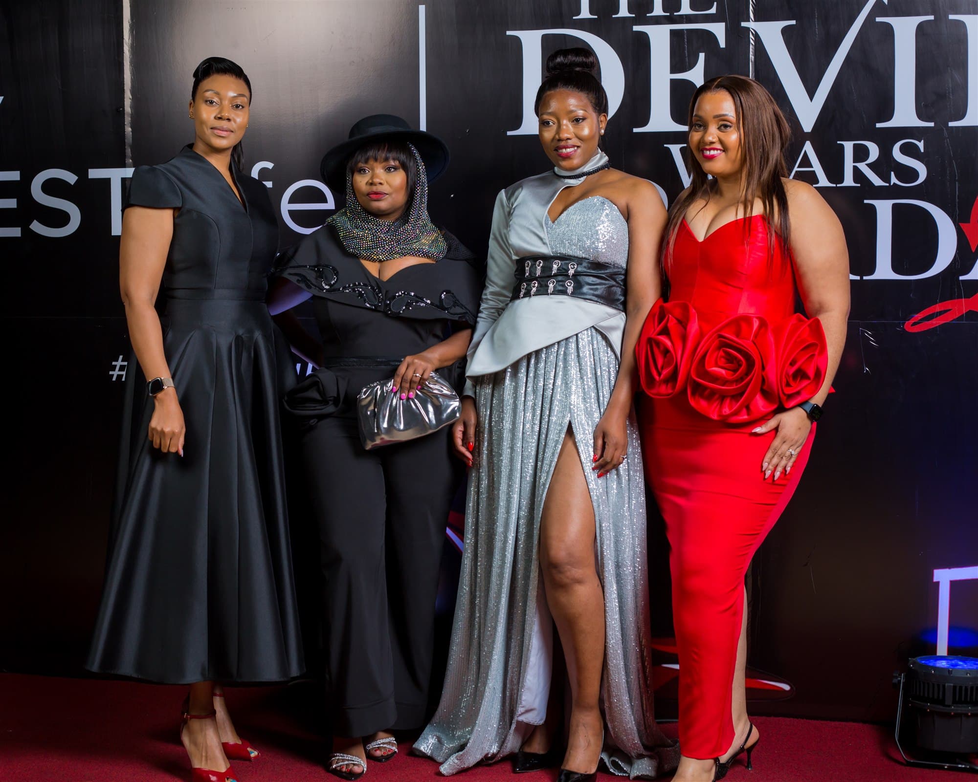 Guests posing at the event backdrop